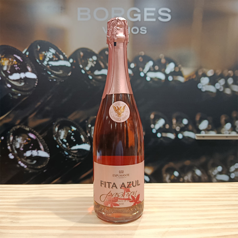 A bottle of Fita Azul Passion by Borges Wines sits on a wooden surface, with blurred wine bottles in the background and "BORGES" visible above.