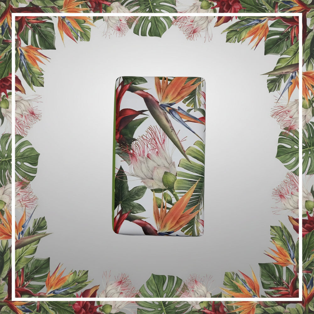 The 100ml Ilha da Madeira 1419 – The Atlantic Garden soap bar features a vibrant tropical floral design and Madeira fragrance, set against a light background with a matching floral border.