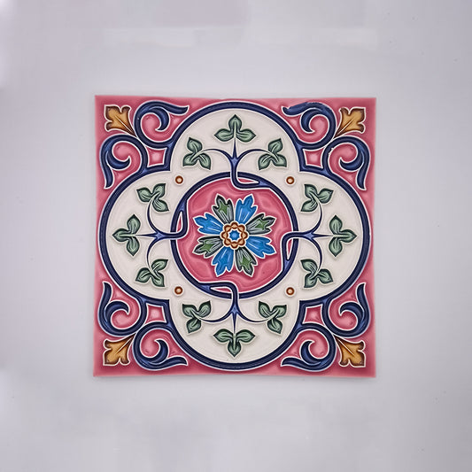 Decorative Estoril Hand Painted Tiles featuring a colorful, symmetrical Portuguese-inspired floral design with a central pink flower, surrounded by blue, green, and red patterns on a cream background from Tejo Shop.