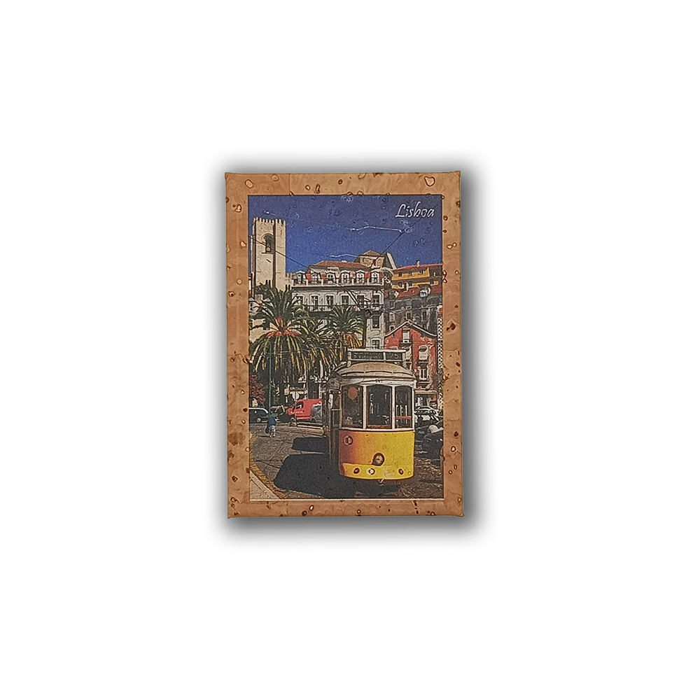 A postcard-style image of a yellow tram on a Lisbon street, with palm trees and historic buildings under a blue sky, adorns the New Jamp "Lisbon Tram - Cork Fridge Magnet"—a perfect eco-friendly Portugal souvenir.