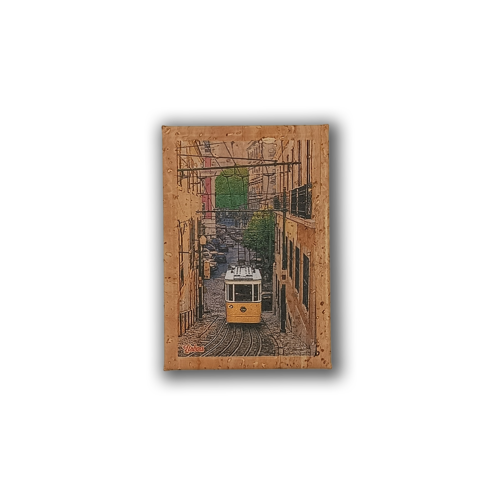 The New Jamp "Bica Lift - Cork Fridge Magnet" features a yellow Lisbon tram on a steep, narrow street with buildings and greenery, framed by a textured cork border, capturing the charming spirit of Portugal.
