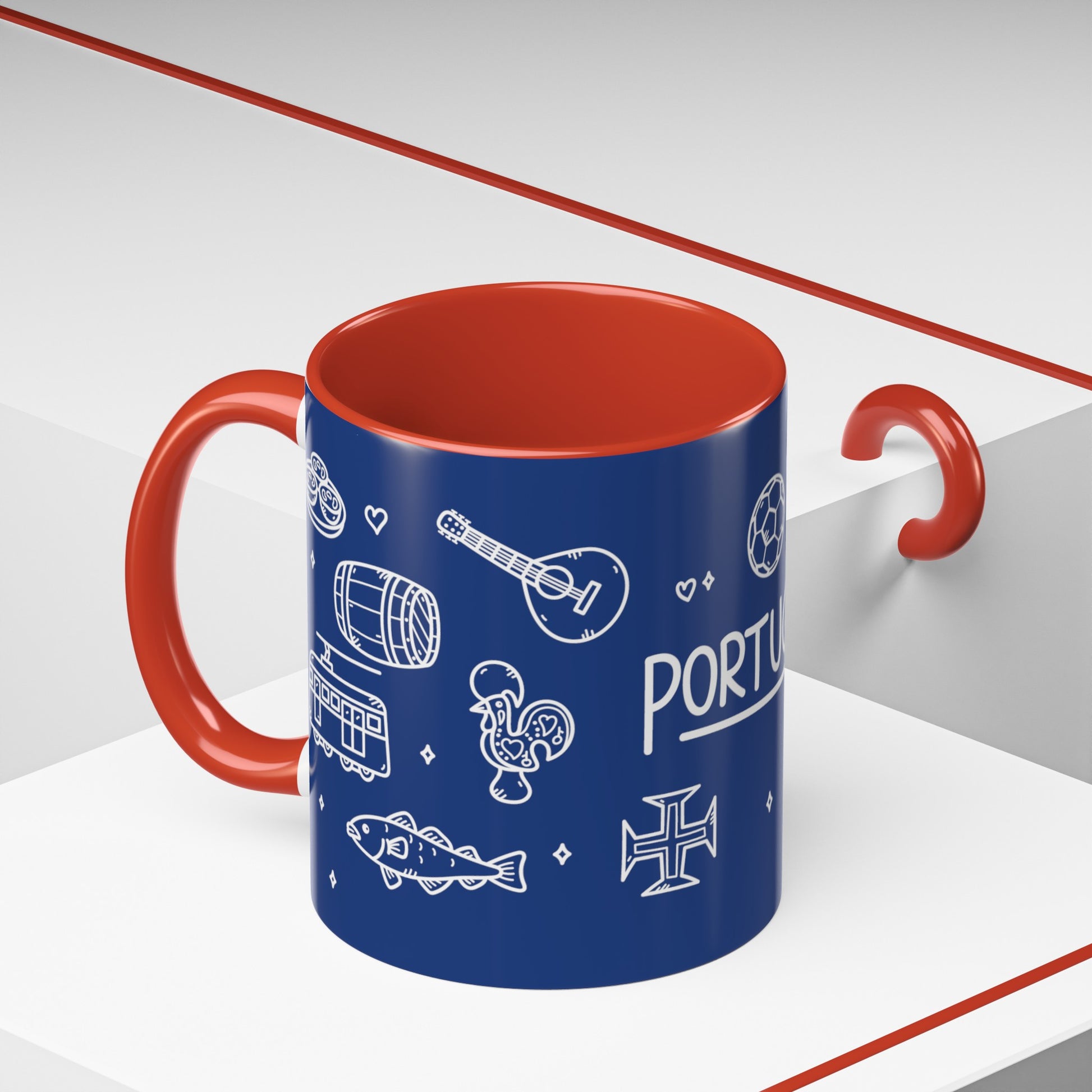 The Portugal Doodles Coffee Mug from Printify features a blue ceramic exterior with a red interior and handle, adorned with various white illustrations like a guitar, fish, rooster, tram, barrel, and cross. "PORTUGAL" is prominently displayed among the images. BPA-free and boasting a glossy finish, the mug is pictured on a white and red surface.