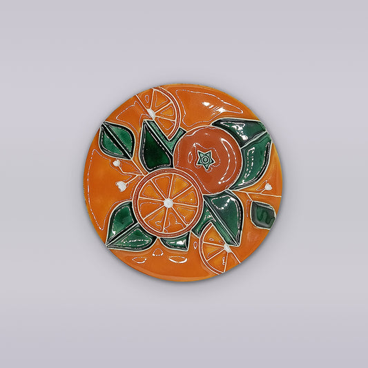 The Algarve Orange Blossom Ceramic Coaster by Miradouro Ceramics features a hand-painted design of oranges and green leaves on an orange background, inspired by classic Portuguese styles.