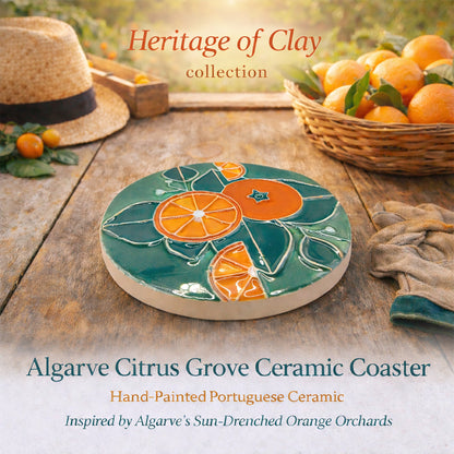 A Miradouro Ceramics Algarve Citrus Grove Ceramic Coaster, hand-painted with an orange and green citrus design, sits among fresh oranges, leaves, a straw hat, and a wicker basket. Discover the "Heritage of Clay" collection.