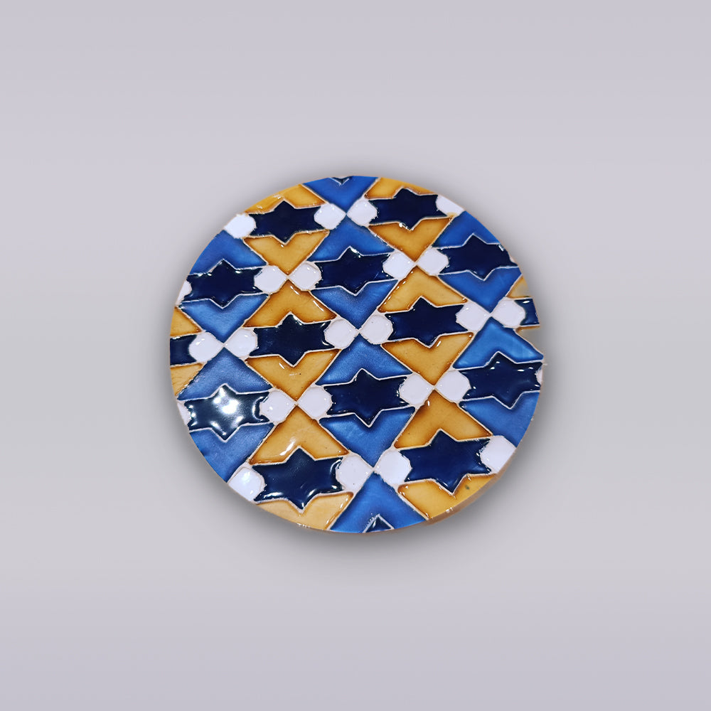 The Atlantic Star Mosaic by Miradouro Ceramics is a round ceramic plate with blue, yellow, and white star and diamond geometric patterns on a light gray background, inspired by classic Portuguese azulejo designs.