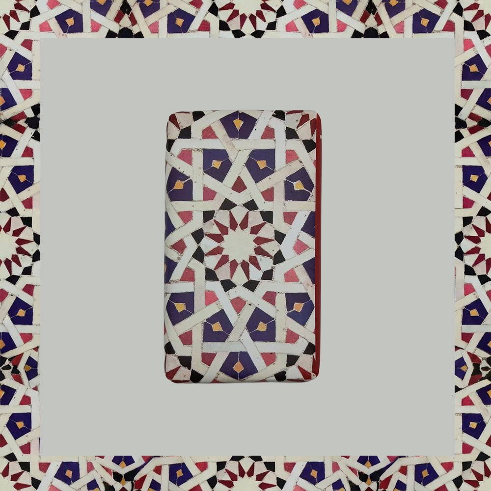 Ceuta 1415 – The First Horizon by 100ml is a rectangular tile with a geometric pattern in red, white, blue, and black shapes on gray—evoking Portuguese handcrafted soap and the Age of Discovery fragrance.