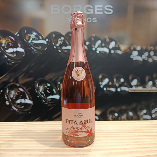 A bottle of Fita Azul Passion by Borges Wines sits on a wooden surface, with blurred wine bottles in the background and "BORGES" visible above.