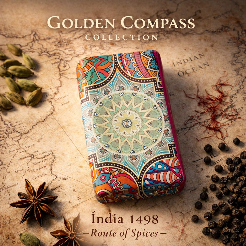 A colorful, ornate case with a mandala design rests on the "Índia 1498 – Route of Spices" map by 100ml, surrounded by cardamom, star anise, and black pepper—an Indian-inspired scent from the Golden Compass Collection.
