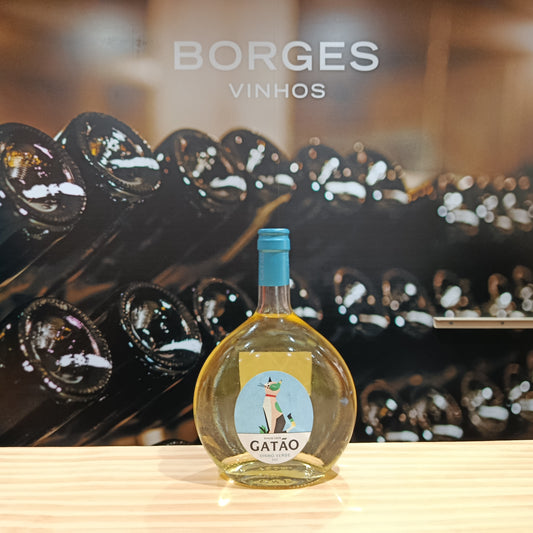 A round bottle of Gatão White by Borges Wines with a blue cap sits on wood before stacked wine bottles and "Borges Vinhos," emphasizing the fresh, fruity character typical of Portuguese wines.