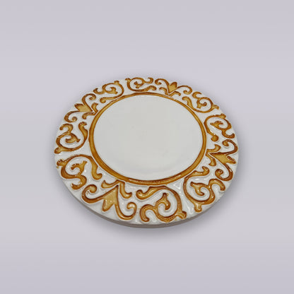 The Manueline Golden Crest Ceramic Coaster by Miradouro Ceramics features an ornate gold pattern inspired by Portuguese décor, set against a white base and shown on a plain light background.