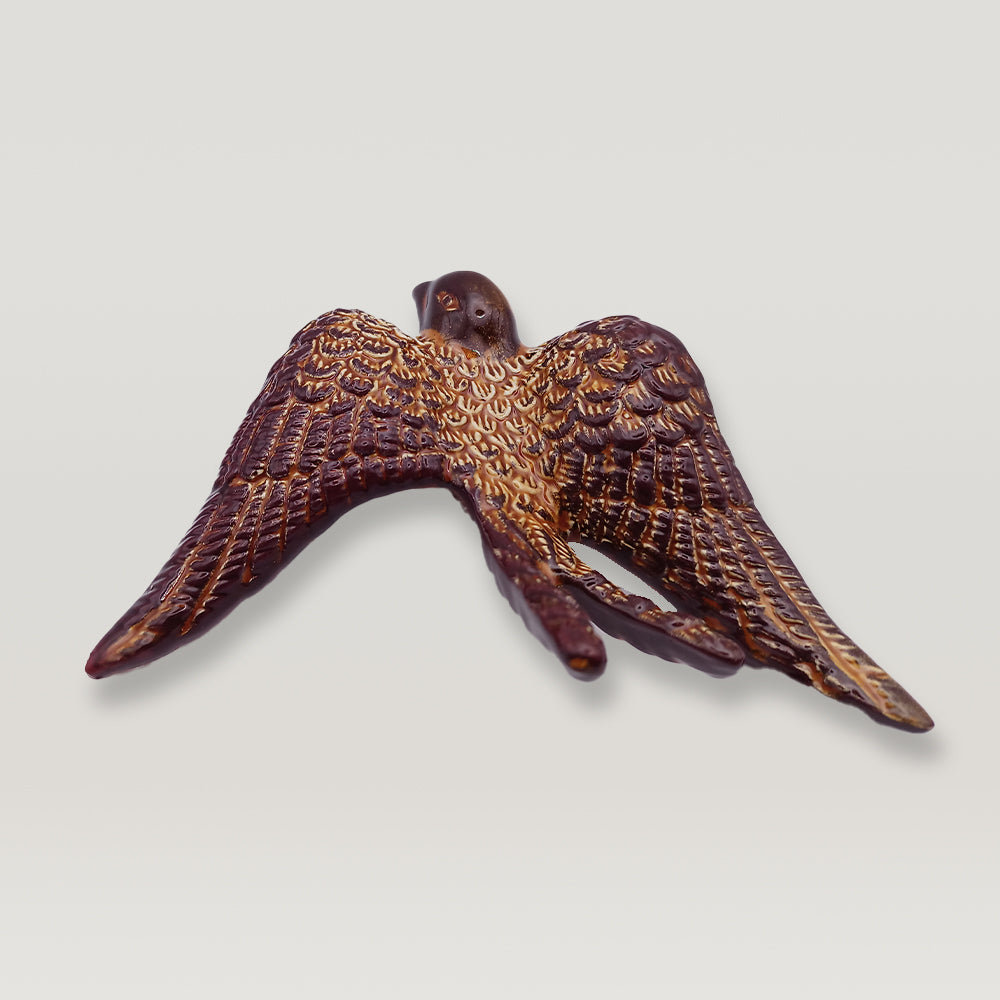 An elegant Portuguese Ceramic Swallow in flight on a white background by Tejo Shop.