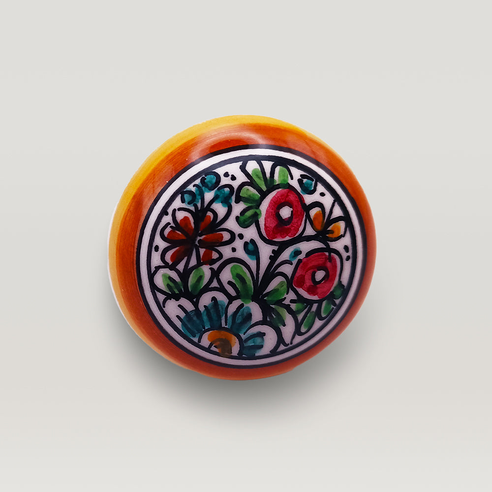 Colorful hand-crafted ceramic wine bottle stopper with floral design on a white background by Tejo Shop.