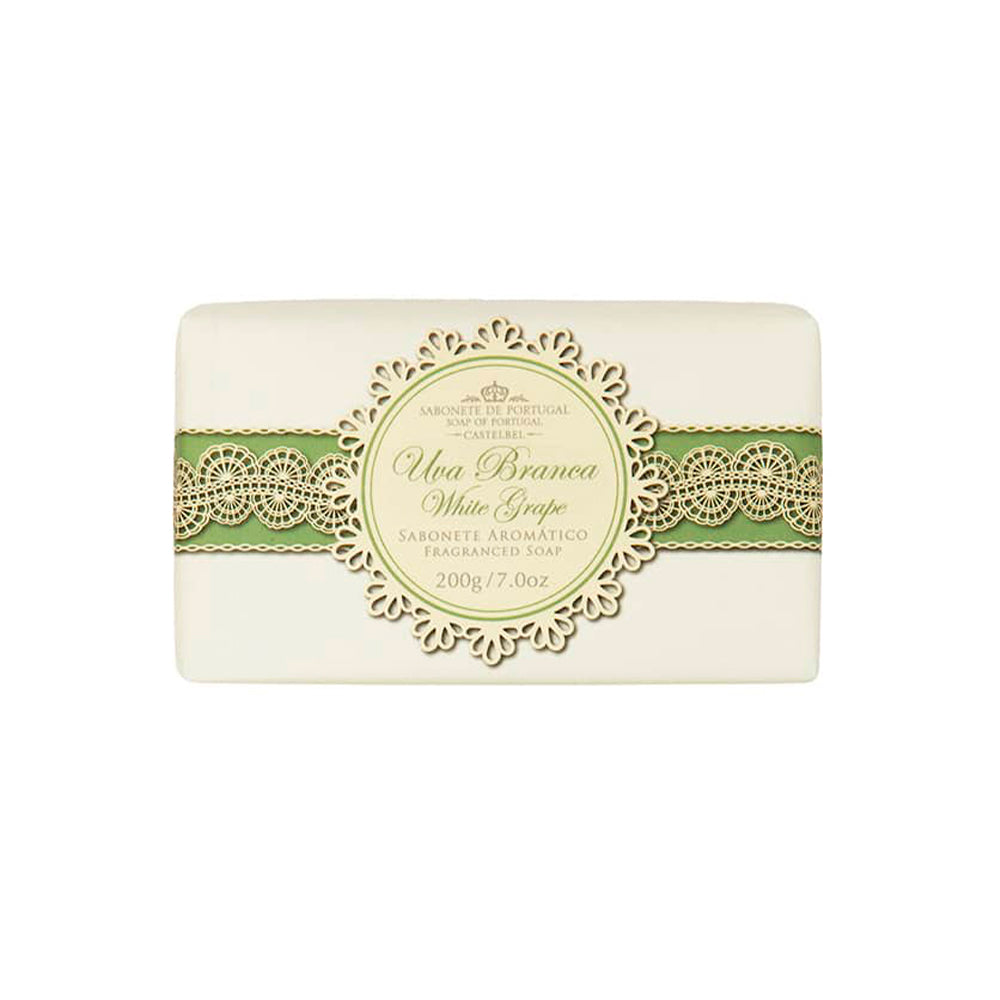 A bar of soap labeled "White Grape Soap 200g" by Castelbel in elegant typography demonstrating Portuguese heritage, showcasing ornate green and gold decorative elements on a creamy background. The soap weighs 200g/7.1 oz.