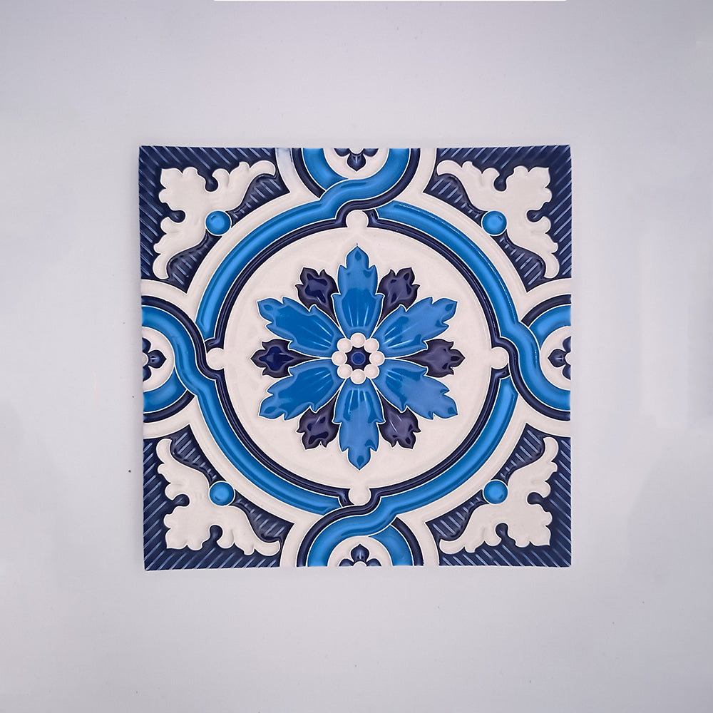 A square handcrafted Traditional Decor Wall Tile by Tejo Shop with an intricate blue and white floral pattern, centered on a white background. The design features symmetric floral motifs with a prominent bloom in the center.