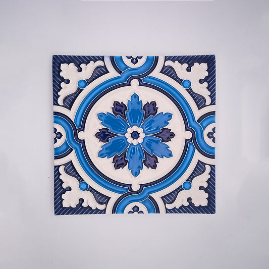 A square handcrafted Traditional Decor Wall Tile by Tejo Shop with an intricate blue and white floral pattern, centered on a white background. The design features symmetric floral motifs with a prominent bloom in the center.