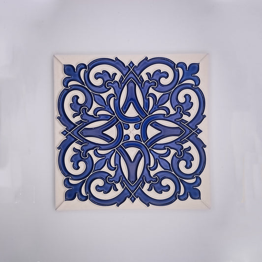 A decorative Tejo Shop ceramic tile featuring intricate blue and white arabesque designs, hand painted in Portugal, symmetrically patterned, centered on a plain white background.