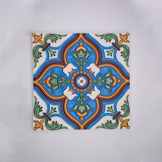 A vibrant hand-painted decorative porcelain tile from Tejo Shop with a symmetrical design featuring a central green and orange motif surrounded by blue, green, and white decorative patterns, set on a white background.