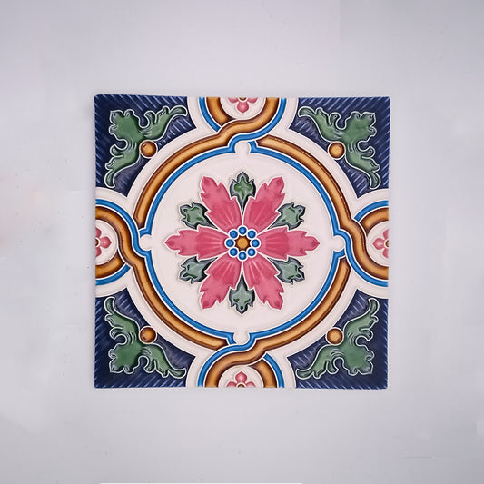 Decorative Backsplash Tile from Tejo Shop featuring a symmetric design with a central floral motif in pink and blue, suitable for use as backsplash tiles, surrounded by swirling patterns and accentuated with green and orange elements.