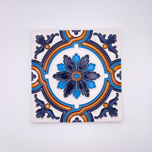 Decorative ceramic tile featuring a symmetrical pattern with a central blue and white floral design, surrounded by gold and dark blue accents on a white background, inspired by traditional Portuguese designs, from Tejo Shop's Margaridas Decorative Tile.