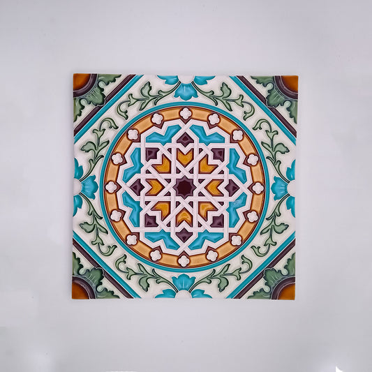 Tejo Shop's handmade decorative tiles feature a detailed, symmetrical geometric pattern in shades of blue, green, orange, and white, set against a neutral background.