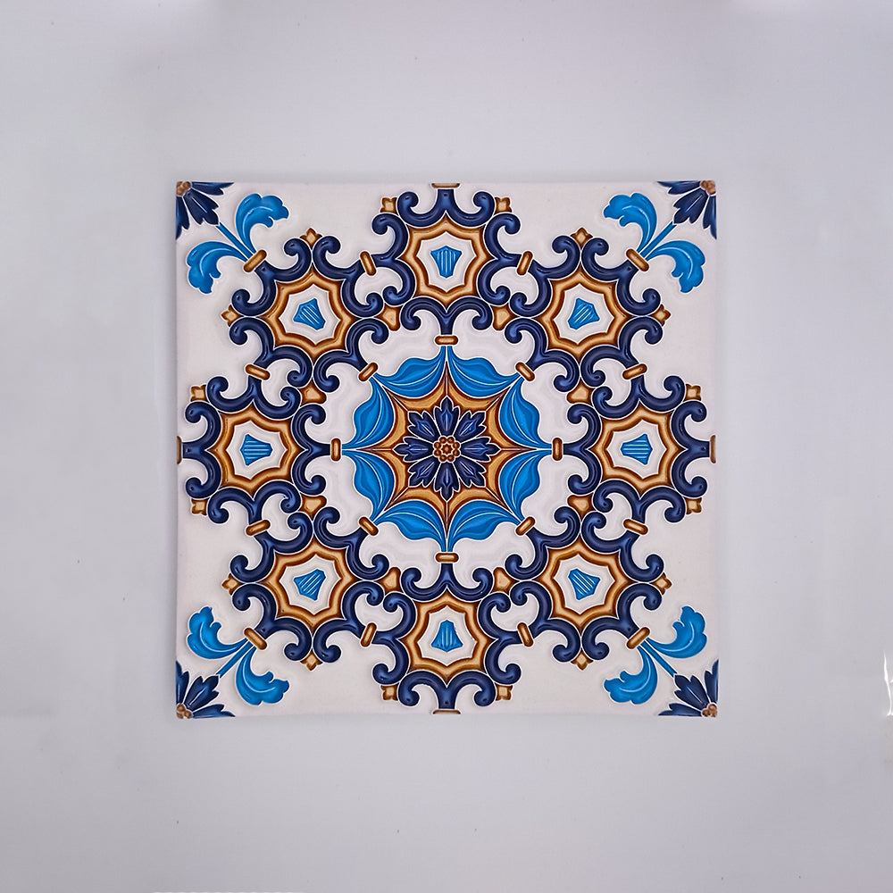 A decorative Tejo Shop Cascais Decor Tile with a symmetrical pattern featuring blue, white, and orange designs, centered around a star-like figure with intricate detailing.