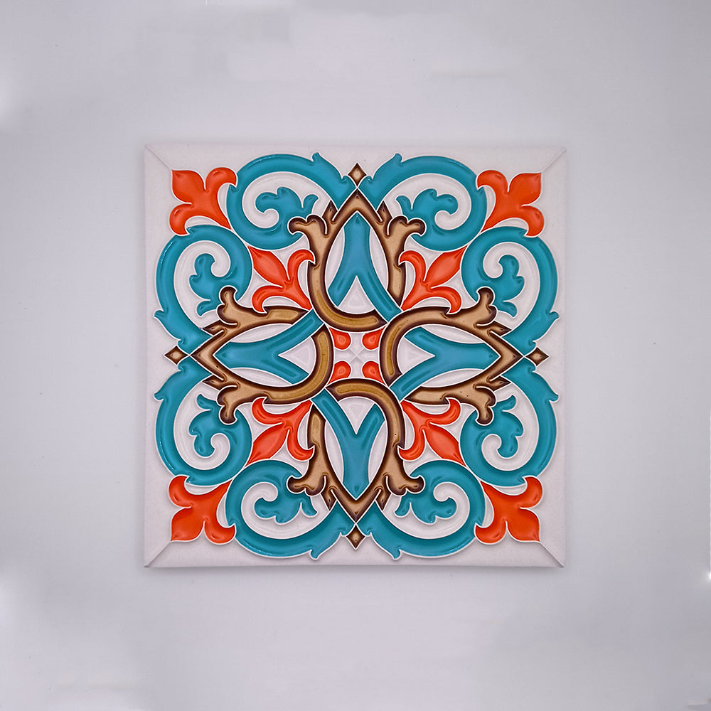 A colorful, Beja Hand Painted Decorative Tile with a symmetrical pattern featuring turquoise and orange floral motifs and beige accents, displayed against a white background by Tejo Shop.