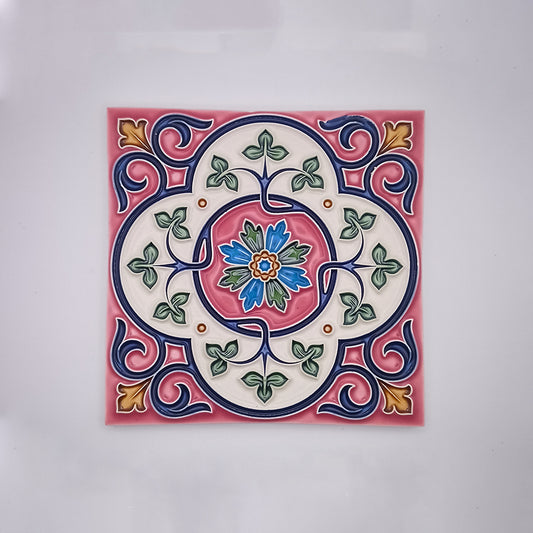 Decorative Estoril Hand Painted Tiles featuring a colorful, symmetrical Portuguese-inspired floral design with a central pink flower, surrounded by blue, green, and red patterns on a cream background from Tejo Shop.