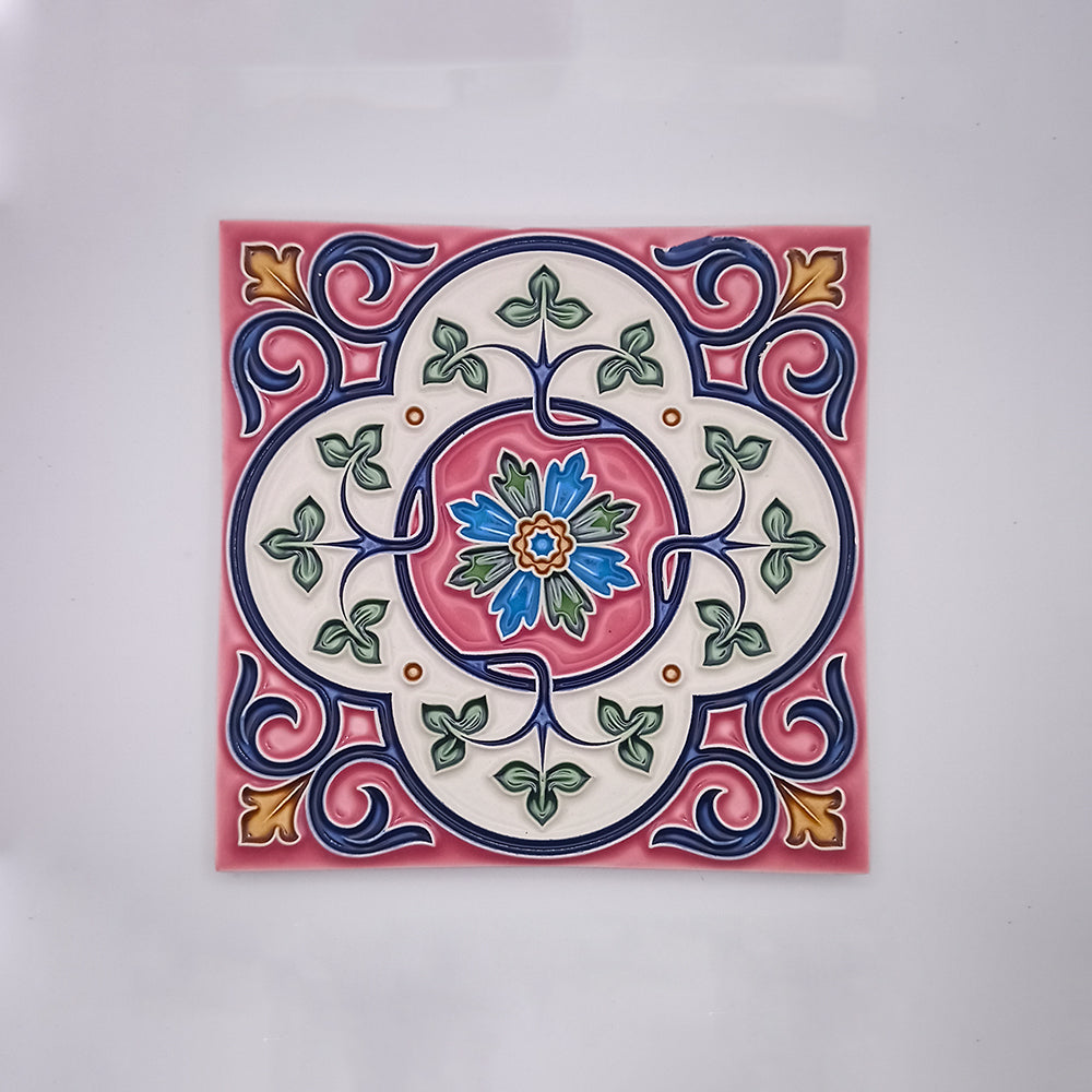 Decorative Estoril Hand Painted Tiles featuring a colorful, symmetrical Portuguese-inspired floral design with a central pink flower, surrounded by blue, green, and red patterns on a cream background from Tejo Shop.