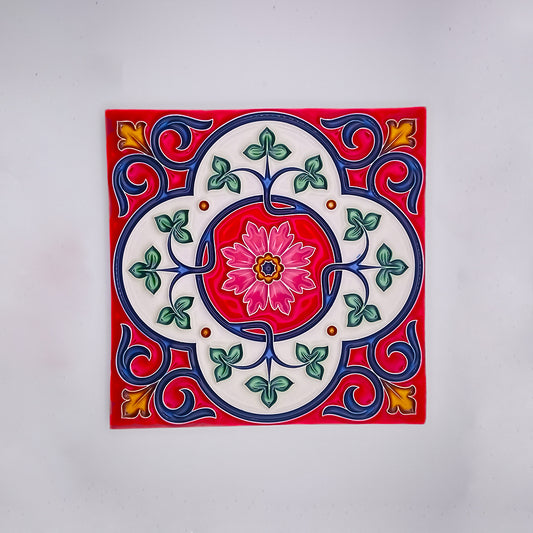 A vibrant square high-quality Iberian tile from Tejo Shop featuring a floral design with a central pink flower, surrounded by blue swirls and green leaf motifs on a white background.