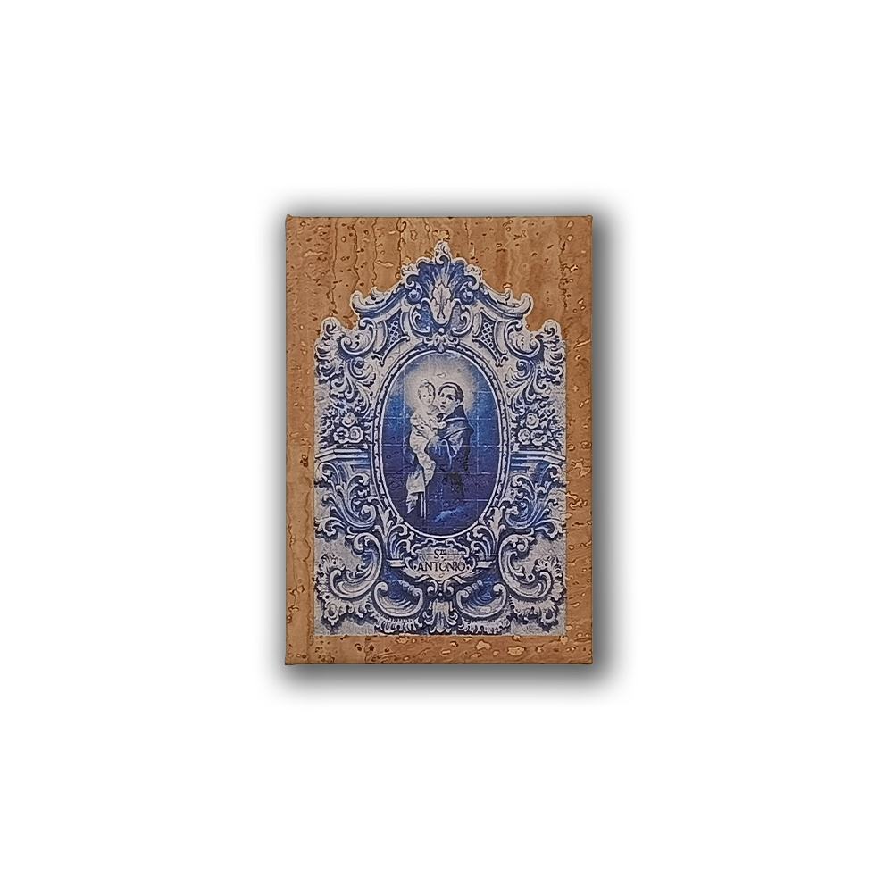 A decorative Saint Anthony cork fridge magnet by New Jamp is mounted on a tan wall in Lisbon, capturing true Portuguese charm with visible water droplets.