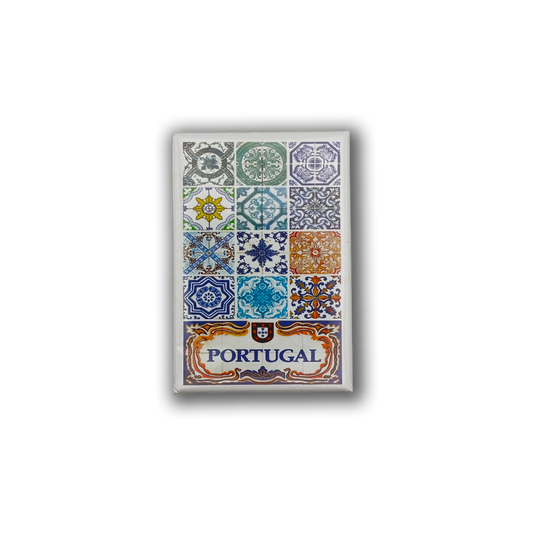 The New Jamp "Photo of Tiles" fridge magnet features twelve colorful Portuguese tile designs above "Portugal" in blue letters, framed by ornate blue, orange, and gold patterns on white—a perfect souvenir for Figueira Square fans.