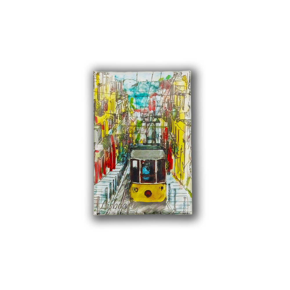 The New Jamp "Painting of a Tram - Fridge Magnet" features a colorful Lisbon tram gliding through vibrant streets with bright buildings, overhead cables, and blue sky—capturing the Portuguese spirit in a lively design.