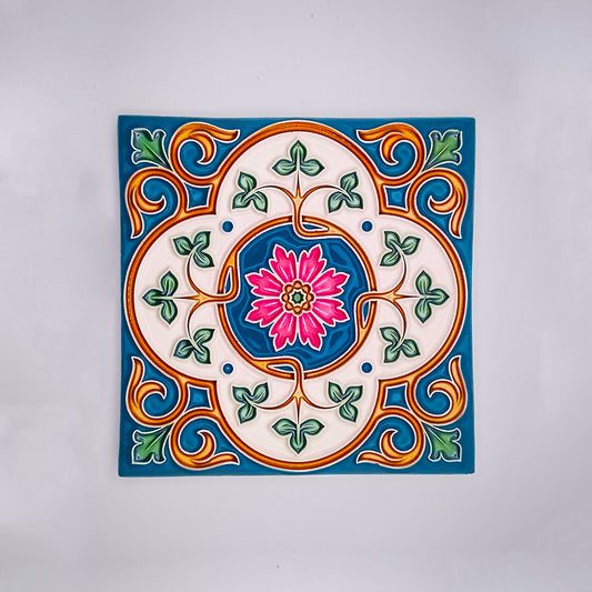 Decorative hand-painted Mediterranean Style Tile from Tejo Shop featuring a colorful floral design with a pink flower at the center surrounded by green, blue, and orange patterns, set against a white background.