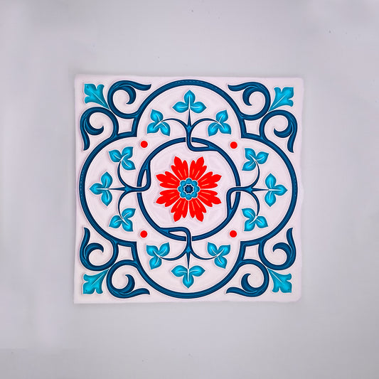 A decorative hand-painted Moroccan Tile from Tejo Shop featuring a central red flower surrounded by blue and turquoise floral patterns and swirls on a white background.