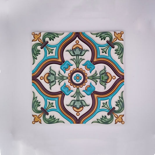 Decorative Alfama Painted Tile featuring a symmetrical pattern with floral motifs in shades of green, blue, brown, and orange on a white background, hand-painted in the style of Tejo Shop.