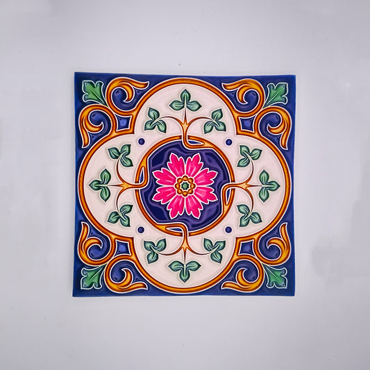 Decorative Spanish Bathroom Tiles by Tejo Shop featuring a vibrant, symmetrical design with a central pink flower encircled by green leaves and orange, blue, and yellow floral patterns on a white background.