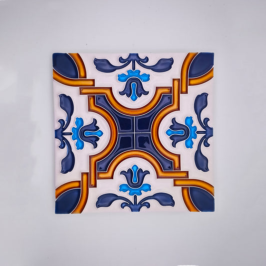 Decorative hand-painted Spanish Style Tiles featuring a symmetrical pattern with blue and orange designs on a white background by Tejo Shop.