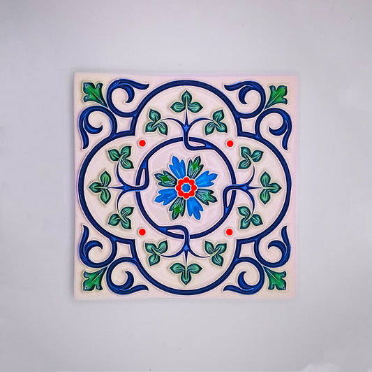 Decorative hand-painted Spanish Bathroom Tile with a colorful floral and vine design in blue, green, and red on a white background, centered with a vivid blue and red flower from Tejo Shop.